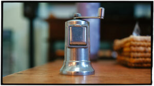 Stainless steel paper grinder on a table