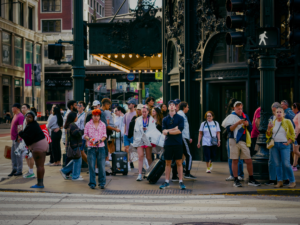 Group of people standing at the crosswalk wait for the signal to change in downtown Chicago